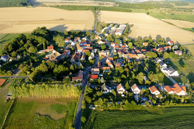 Der Ortsteil Lützeroda mit Wohnhäusern, Wiesen und Feldern.